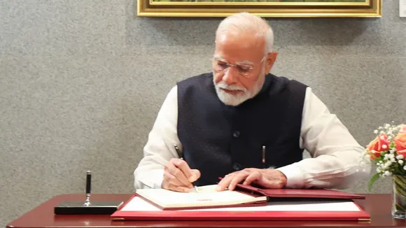Prime Minister Narendra Modi with his Singapore counterpart Lawrence Wong signs a visitor's book, in Singapore
