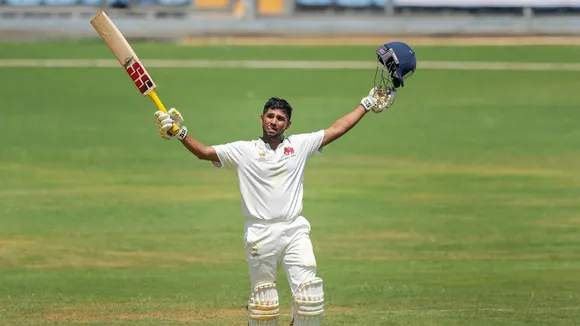 Mumbai's Musheer Khan celebrates his century during the third day of the Ranji Trophy final match between Mumbai and Vidarbha