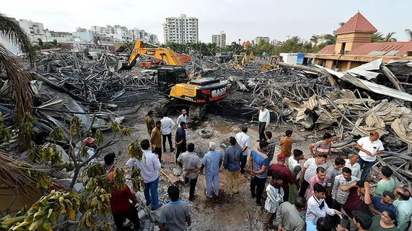 Earth movers dismantle debris of a fire incident at TRP game zone at Rajkot, Gujarat on May 26, 2024.