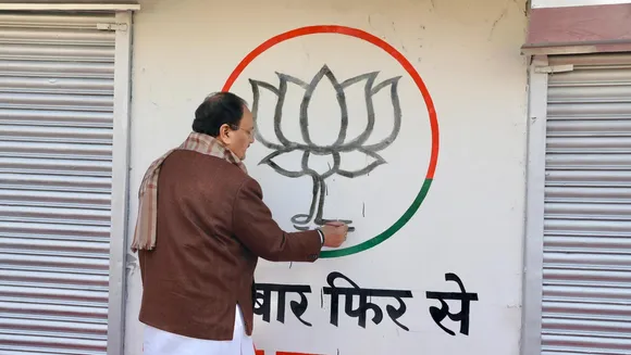 BJP National President J.P. Nadda paints party's logo on a wall during the launch of party's Wall Writing Abhiyan, in New Delhi