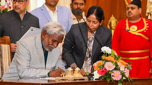 JMM leader Champai Soren signs documents after taking oath as Jharkhand CM during the swearing-in ceremony, at Raj Bhawan in Ranchi