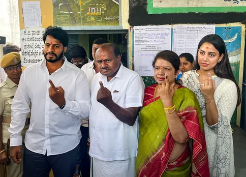 Former Karnataka CM H.D. Kumaraswamy with his family members after casting vote for Karnataka Assembly elections