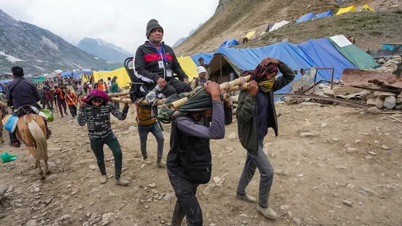 A pilgrim being carried on a palanquin at Sheshnag during Amarnath Yatra 2023