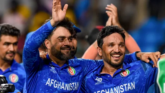 Afghanistan's captain Rashid Khan with teammate Gulbadin Naib acknowledges fans after Afghanistan won the ICC Men's T20 World Cup cricket match against Bangladesh, at Arnos Vale Ground, Kingstown, Saint Vincent and the Grenadines, Monday, June 24, 2024