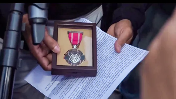 Wrestler Bajrang Punia holds his Padma Shri award near the Kartavya Path, in New Delhi, Friday, Dec. 22, 2023. The Olympic medallist grappler on Friday decided to return the Padma Shri award in protest over the election of Sanjay Singh, a Brij Bhushan Sharan Singh loyalist, as the president of Wrestling Federation of India (WFI).