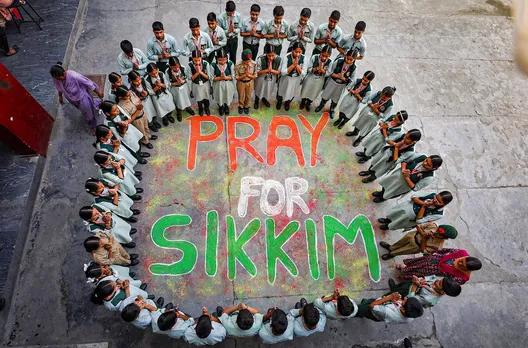 School students pray for 23 Army personnel missing in flash flood triggered by clouburst in Sikkim, in Jammu, Wednesday, Oct. 4, 2023.