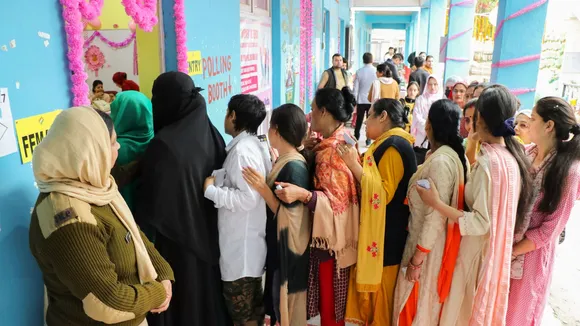 Voters wait in a queue at a polling station to cast their votes for the first phase of Lok Sabha elections, in Doda, Friday, April 19, 2024