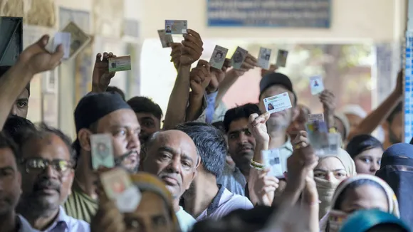 People wait in queues to cast their votes during the sixth phase of Lok Sabha elections, at a polling booth in East Delhi, Saturday, May 25, 2024