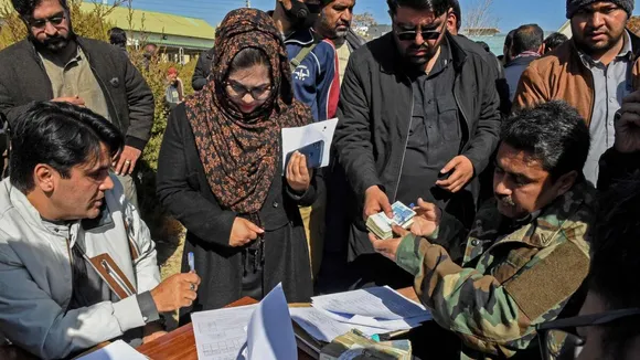 Locals arrive to cast vote during the general elections, in Karachi