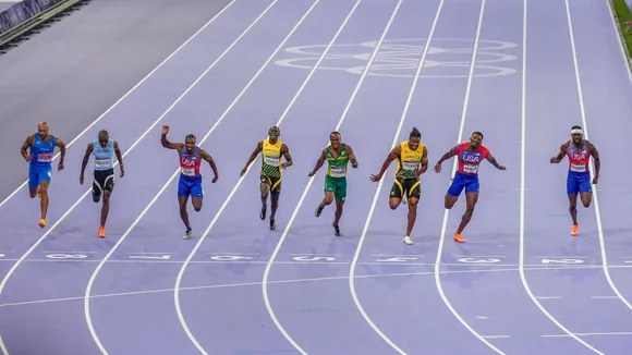 Noah Lyles (2nd L) of the United States crosses the finish line to win win the gold medal in the men's 100 meters final at the 2024 Summer Olympics, in Saint-Denis, France, Sunday, Aug. 4, 2024.