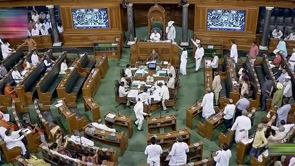 Opposition MPs protest in the Lok Sabha demanding PM Narendra Modi's statement in the House on Manipur crisis during the Monsoon session of Parliament