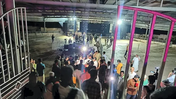 People gather near the area at Cochin University where a stampede killed at least four students and left several injured during the anniversary celebrations, in Kochi, Saturday, Nov. 25, 2023.