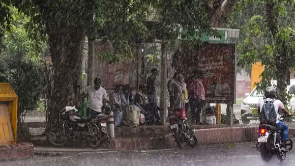 People take shelter amid Monsoon rains, in New Delhi, Monday, July 22, 2024.