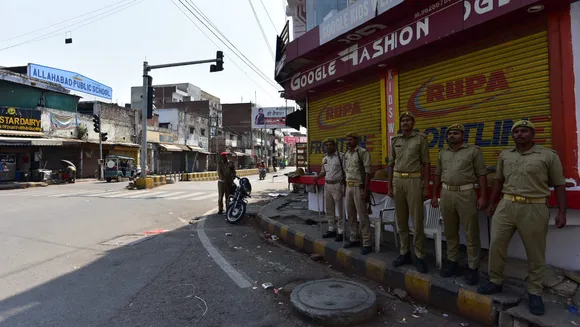 Police personnel stand guard as an area wears a deserted look following the imposition of Section 144 in Uttar Pradesh after mafioso-turned-politician Atiq Ahmed and his brother Khalid Azim aka Ashraf were shot dead by unknown assailants in Prayagraj on April 16