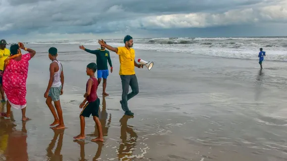 Beach guards ask tourists to stay away from the rough sea amid the formation of a deep depression over the Bay of Bengal, in Puri, Monday, Sept. 9, 2024.