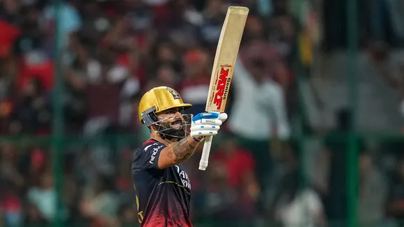 Virat Kohli celebrates after scoring a half-century against Lucknow Super Giants at M Chinnaswamy Stadium in Bengaluru on April 10