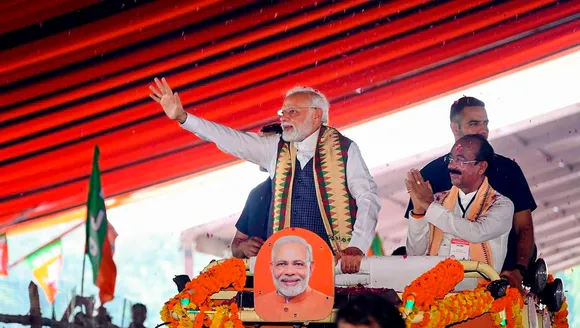 Prime Minister Narendra Modi with Chhattisgarh BJP President Arun Sao waves at supporters as he arrives for the 'Parivartan Mahasankalp' rally, in Bilaspur, Saturday