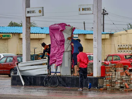 Workers cover fuel station after government’s advisory for evacuation ahead of cyclone Biparjoy’s landfall, at Naliya village, in Kutch district