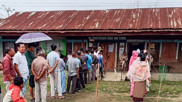 People wait to cast their votes for Lok Sabha elections, in Manipur, Friday, April 19, 2024.