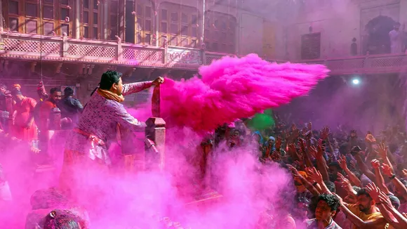 Devotees play 'Holi' at Sri Radha Vallabh temple in Vrindavan near Mathura, Saturday, March 23, 2024