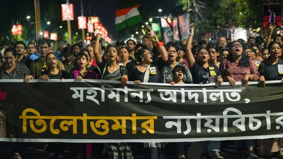 People take part in a protest march over the alleged sexual assault and murder of a trainee doctor, in Kolkata, Sunday, Sept. 8, 2024.