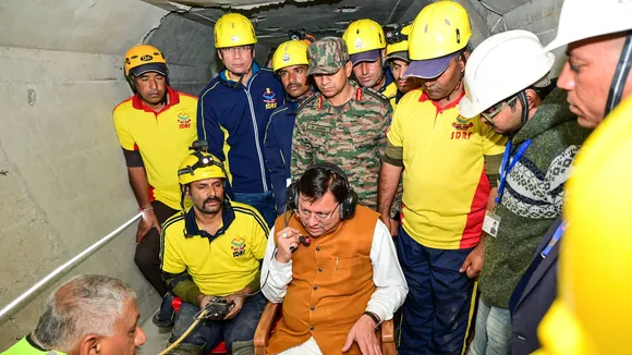 Uttarakhand Chief Minister Pushkar Singh Dhami talks with workers trapped inside the under-construction tunnel between Silkyara and Dandalgaon