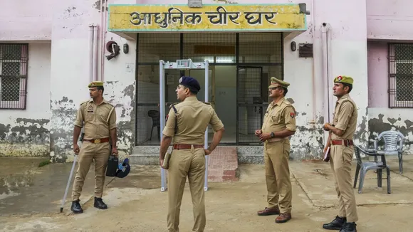 Police personnel keep vigil outside a mortuary a day after a stampede occured during a satsang in Hathras district 