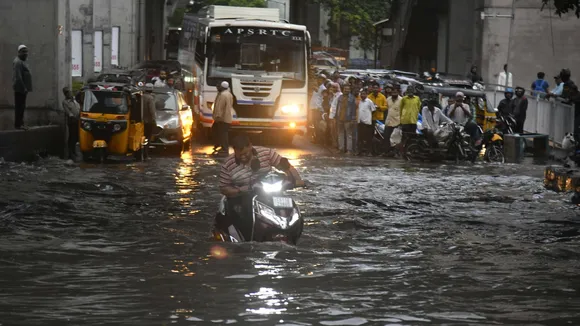 A man rides a scooter on a flooded road after heavy monsoon rains, in Hyderabad, Tuesday, Aug. 20, 2024.