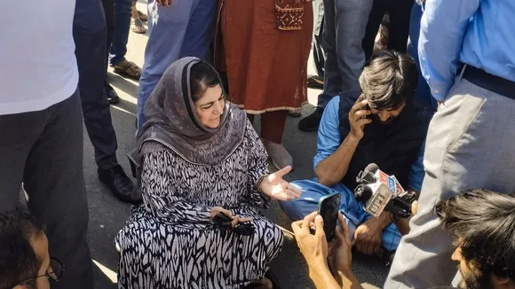 PDP chief Mehbooba Mufti sits on a protest after the alleged detention of her party workers, on the day of voting in the sixth phase of Lok Sabha elections, in Anantnag district, Saturday, May 25, 2024