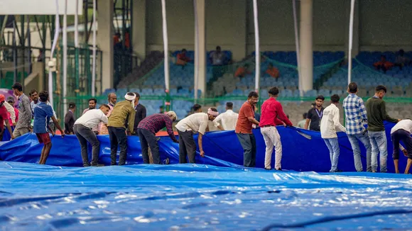 Ground staff remove covers off the field before the start of play during the first day of the second test cricket match between India and Bangladesh, at Green Park stadium in Kanpur, Friday, Sept. 27, 2024