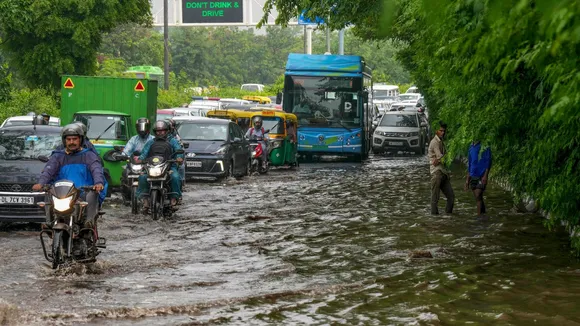 Vehicles pass through a waterlogged road after heavy monsoon rains, at ITO in New Delhi, Wednesday, July 24, 2024.