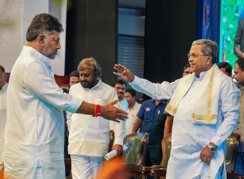 Karnataka Chief Minister Siddaramaiah meets Deputy Chief Minister DK Shivakumar during an event on World Environment Day, in Bengaluru