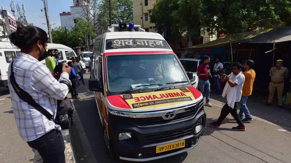An ambulance carries the bodies of mafioso-turned-politician Atiq Ahmed and his brother Khalid Azim aka Ashraf from a hospital in Prayagraj on April 16