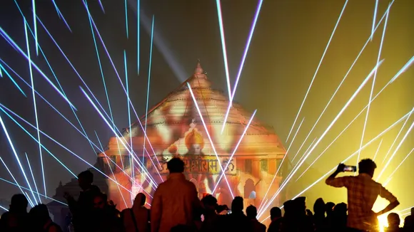 Invitees attend a laser show inside the the Ram Mandir premises after its consecration ceremony, in Ayodhya, Monday, Jan. 22, 2024. 