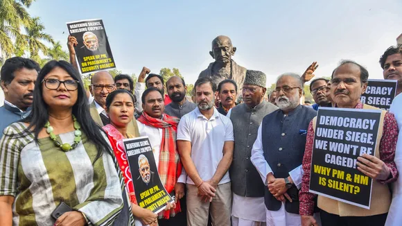 Congress MPs Mallikarjun Kharge and Rahul Gandhi with suspended Opposition MPs during a protest at Mahatma Gandhi statue