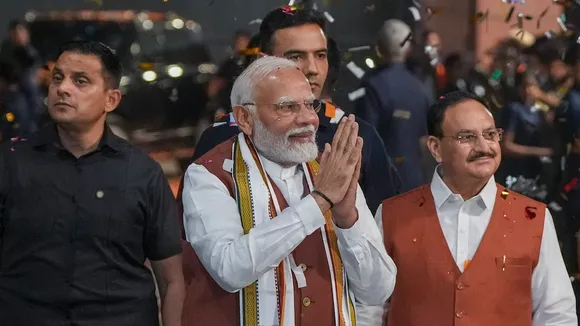Prime Minister Narendra Modi greets the gathering upon his arrival at the party headquarters during an event after the declaration of results for the Haryana and Jammu and Kashmir Assembly elections, in New Delhi, Tuesday, Oct. 8, 2024