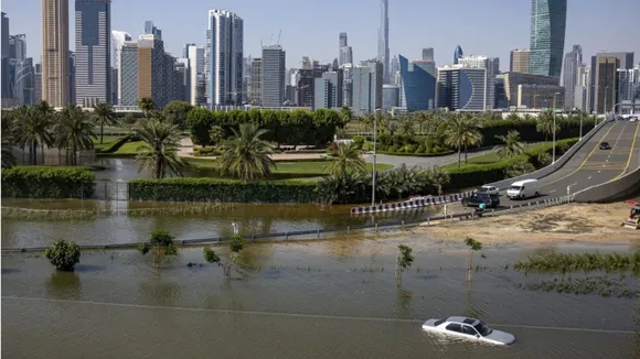 An abandoned vehicle sits in floodwater near the Burj Khalifa in Dubai, UAE, after heavy rain on April 18, 2024. 
