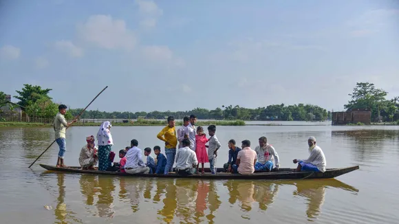 A groom along with his family members use a boat to reach the wedding venue during floods, at Kampur, in Nagaon district, Thursday, June 20, 2024.