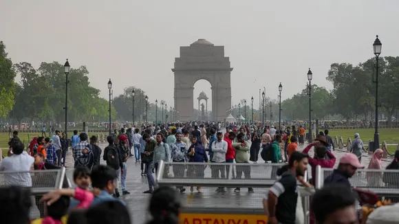 Visitors at Kartavya Path after rain, in New Delhi, Saturday, April 13, 2024