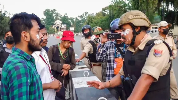Security personnel talk to students during their protest over recent violence, in Imphal, Tuesday, Sept. 10, 2024.