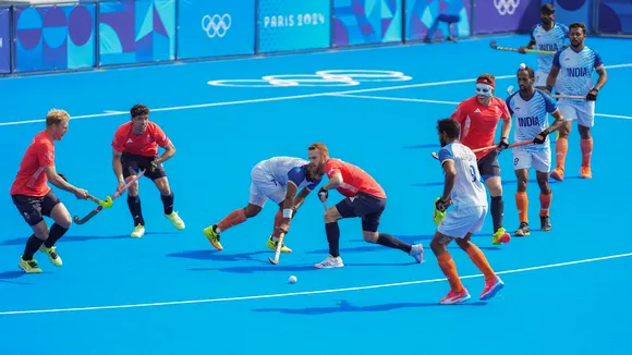 India's Manpreet Singh (7) vies for the ball with Great Britain's Jack Waller (3) during the Hockey Men's Quarterfinal match between India and Great Britain at the 2024 Summer Olympics, at Yves-du-Manoir Stadium, in Colombes, France, Sunday, Aug. 4, 2024.