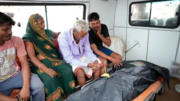 Family members of 37-year-old Ruby, victim of a stampede, mourn after receiving her body from a mortuary as they prepare to leave for their hometown, outside Hathras district hospital, Uttar Pradesh, India, Wednesday, July 3, 2024