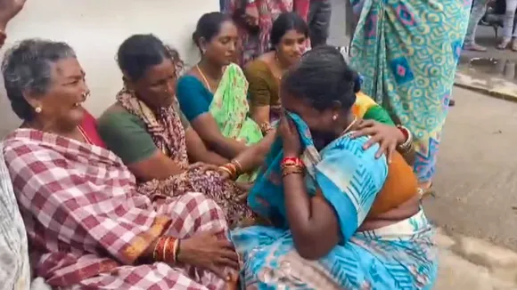 Relatives of victims of the Atchutapuram pharma unit fire mourn, in Anakapalli district, Thursday, Aug. 22, 2024.