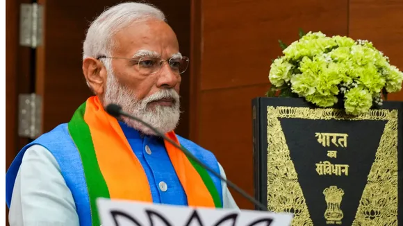 Prime Minister Narendra Modi during the release of the party's election manifesto Sankalp Patra at the party headquarters, in New Delhi, Sunday, April 14, 2024