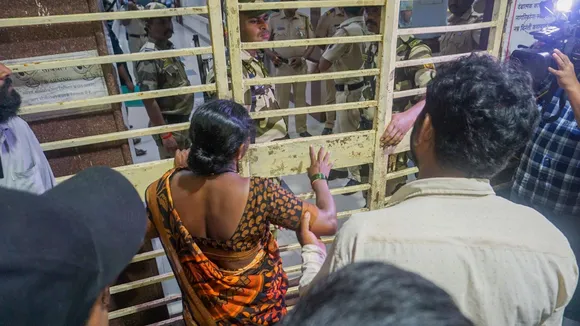 Parents of Akshay Shinde, the accused in the Badlapur sexual assault case of two minor girls, outside the Kalwa Hospital where his body was brought after the police encounter, in Thane, late Monday night, Sept. 23, 2024.