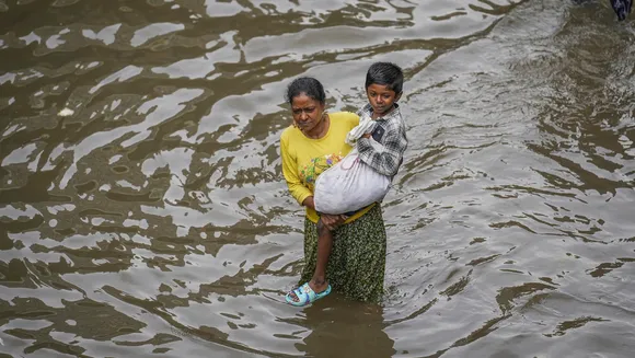 A commuter on a flooded road after heavy rainfall owing to Cyclone Michaung, in Chennai