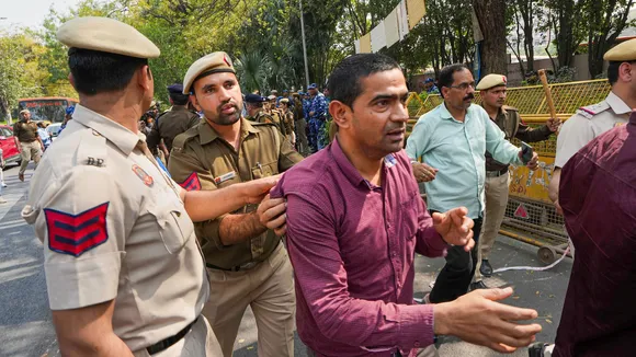 Delhi Police personnel detain Aam Aadmi Party (AAP) supporters during a protest against the CBI's questioning of Delhi Deputy Chief Minister Manish Sisodia in the liquor policy case