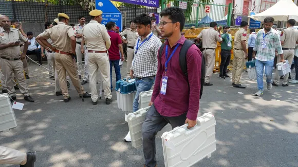Polling officials leave a distribution center at Gole Market after receiving election material on the eve of the sixth phase of Lok Sabha polls, in New Delhi, Friday, May 24, 2024