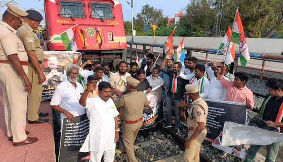Congress party workers stop a train in protest against the conviction of Rahul Gandhi in a criminal defamation case