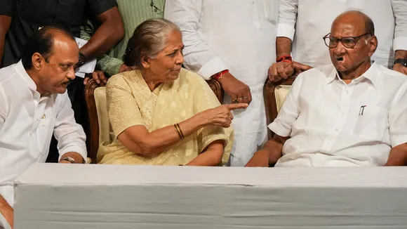 Sharad Pawar with his wife and party leader Ajit Pawar during a book launch event on May 2